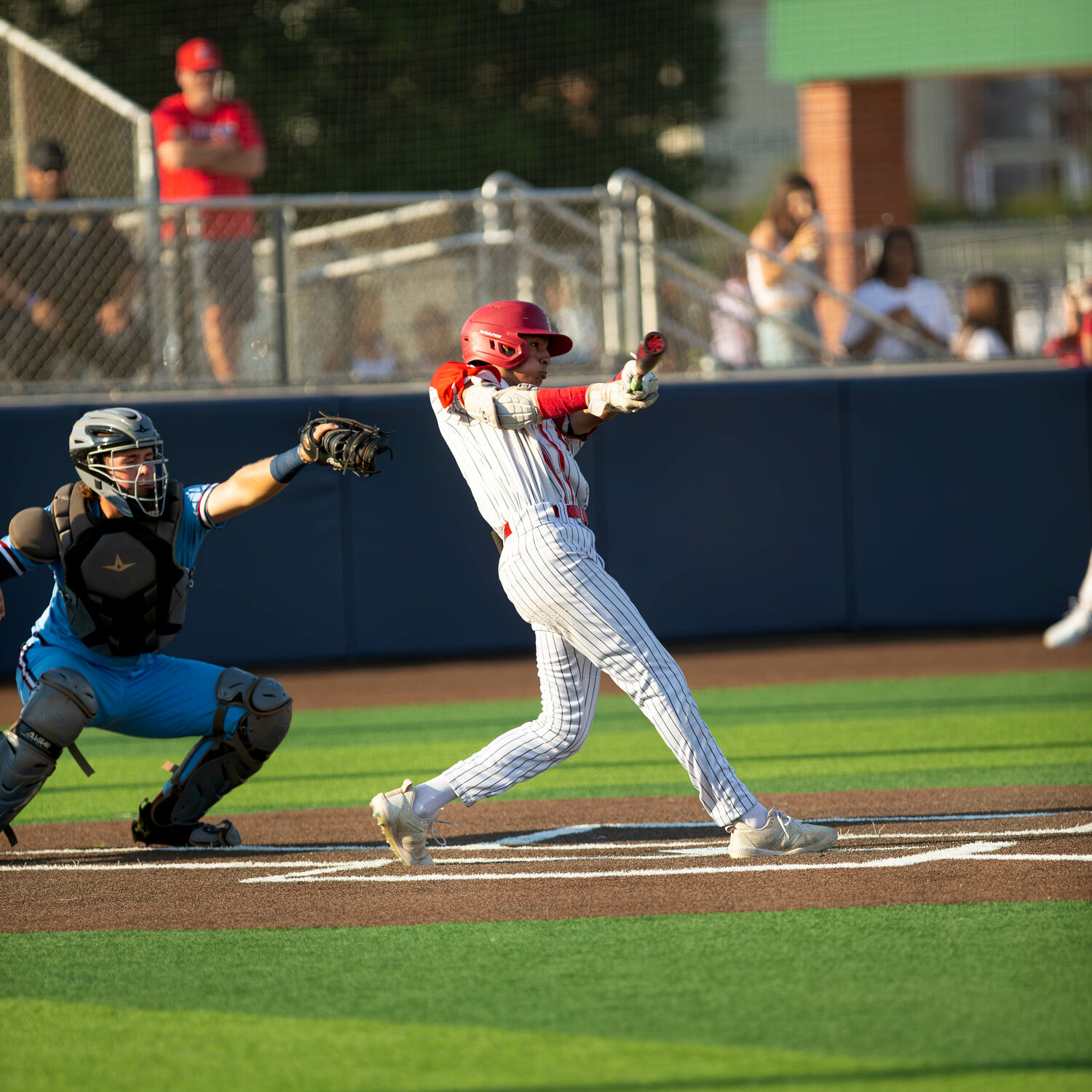 AJ Atkinson hits during Thursday's Regional Quarterfinal game between Katy and Tompkins at Cy-Springs.